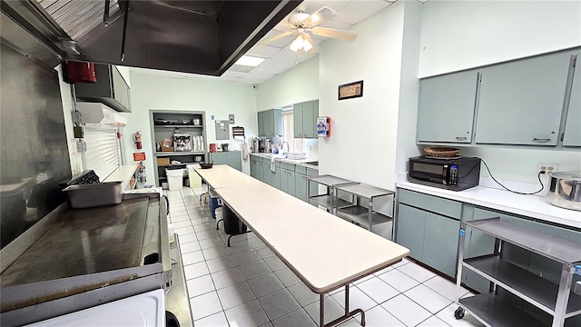 4359 Tahitian Gardens Cir Unit A, Holiday, FL 34691 - kitchen with black microwave, a ceiling fan, light tile patterned flooring, and light countertops