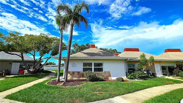 4359 Tahitian Gardens Cir Unit A, Holiday, FL 34691 - ranch-style house featuring a front lawn, stucco siding, and stone siding