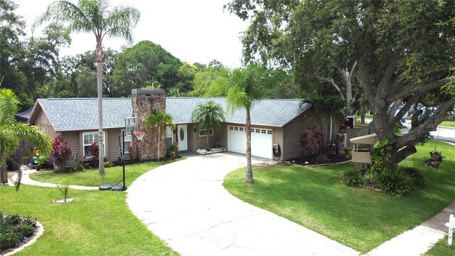 713 Rustic Oaks Dr, Palm Harbor, FL 34684 - ranch-style home with a garage, concrete driveway, a front lawn, roof with shingles, and a chimney