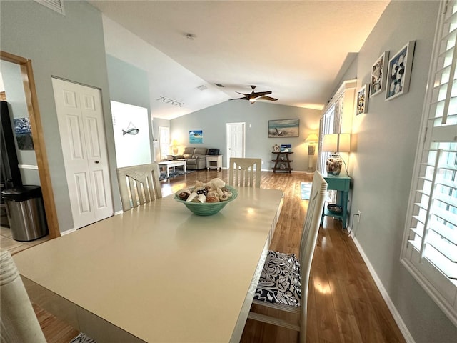 713 Rustic Oaks Dr, Palm Harbor, FL 34684 - dining space with vaulted ceiling, wood finished floors, and ceiling fan
