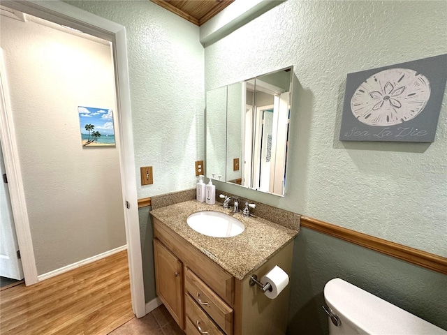 713 Rustic Oaks Dr, Palm Harbor, FL 34684 - bathroom featuring vanity, a textured wall, and wood finished floors