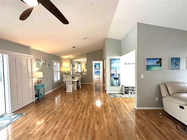 713 Rustic Oaks Dr, Palm Harbor, FL 34684 - foyer entrance featuring vaulted ceiling, light wood-style floors, a textured ceiling, and ceiling fan