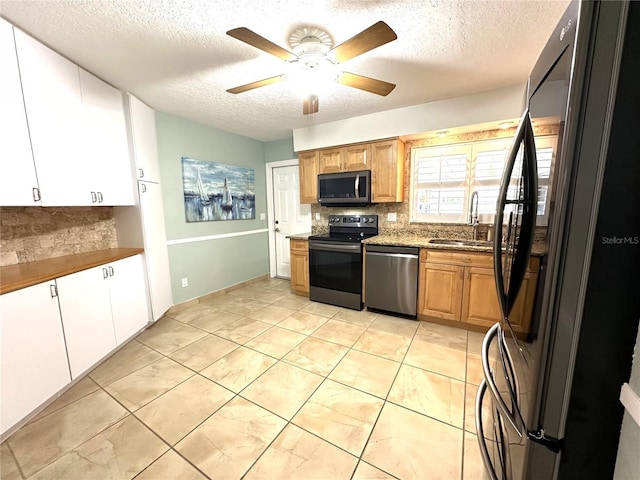 713 Rustic Oaks Dr, Palm Harbor, FL 34684 - kitchen featuring appliances with stainless steel finishes, decorative backsplash, ceiling fan, a textured ceiling, and light tile patterned flooring