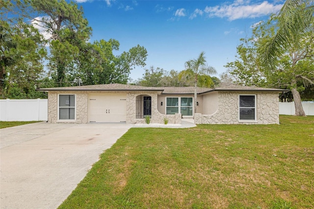 7607 New York Ave, Hudson, FL 34667 - view of front of house with stone siding, concrete driveway, and a garage