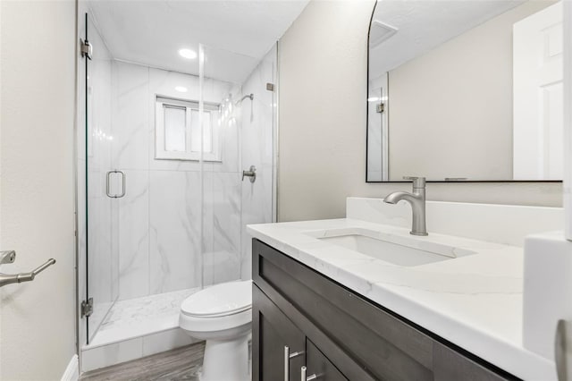7607 New York Ave, Hudson, FL 34667 - full bath featuring vanity, a marble finish shower, wood finished floors, and recessed lighting