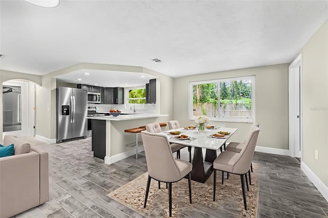7607 New York Ave, Hudson, FL 34667 - dining area with arched walkways, light wood-style floors, and recessed lighting