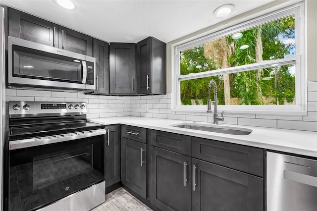 7607 New York Ave, Hudson, FL 34667 - kitchen with appliances with stainless steel finishes, light countertops, plenty of natural light, and backsplash