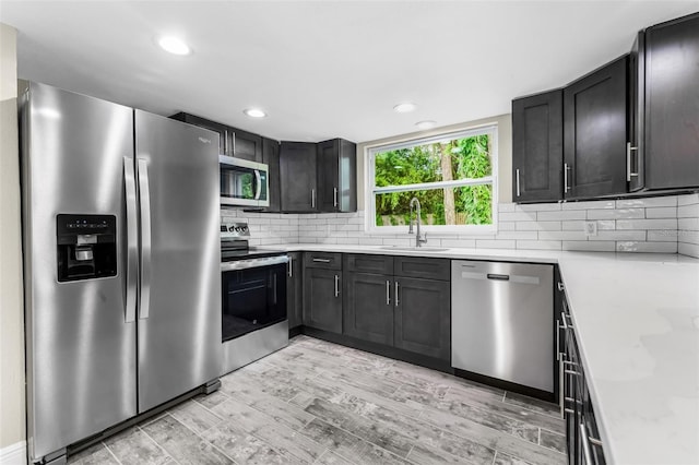 7607 New York Ave, Hudson, FL 34667 - kitchen featuring appliances with stainless steel finishes, decorative backsplash, light wood finished floors, and recessed lighting