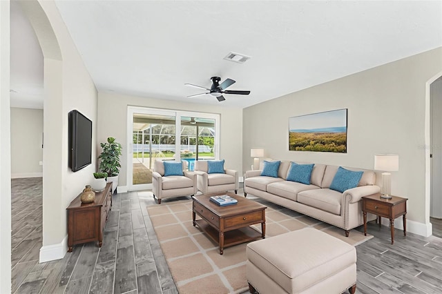 7607 New York Ave, Hudson, FL 34667 - living room featuring arched walkways, light wood-type flooring, and ceiling fan
