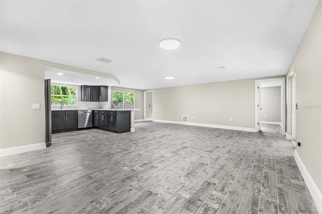 7607 New York Ave, Hudson, FL 34667 - unfurnished living room featuring light wood-type flooring and recessed lighting
