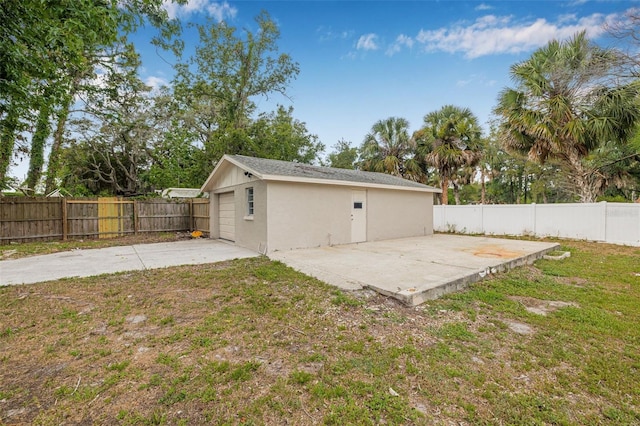 7607 New York Ave, Hudson, FL 34667 - fenced backyard with a patio and an outbuilding