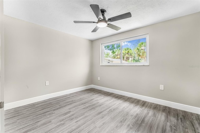 7607 New York Ave, Hudson, FL 34667 - spare room with wood finished floors, a ceiling fan, and a textured ceiling