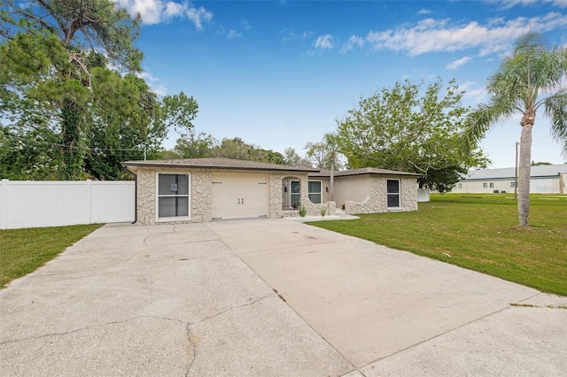 7607 New York Ave, Hudson, FL 34667 - view of front of home with stone siding, concrete driveway, and a garage