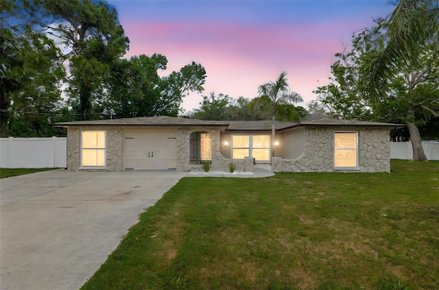 7607 New York Ave, Hudson, FL 34667 - view of front facade with stone siding, driveway, and an attached garage