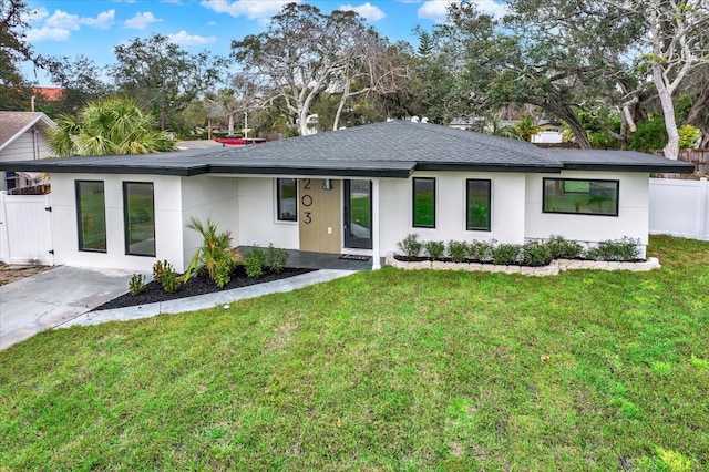 203 Driftwood Dr W, Palm Harbor, FL 34683 - view of front of house with a shingled roof and stucco siding
