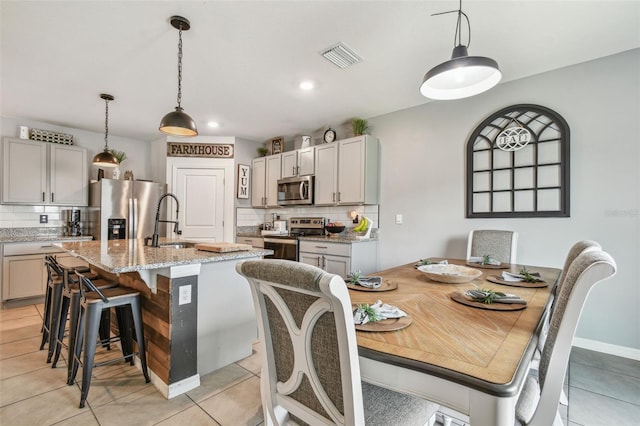 33678 Jasper Stone Dr, Wesley Chapel, FL 33543 - dining room with light tile patterned floors and recessed lighting