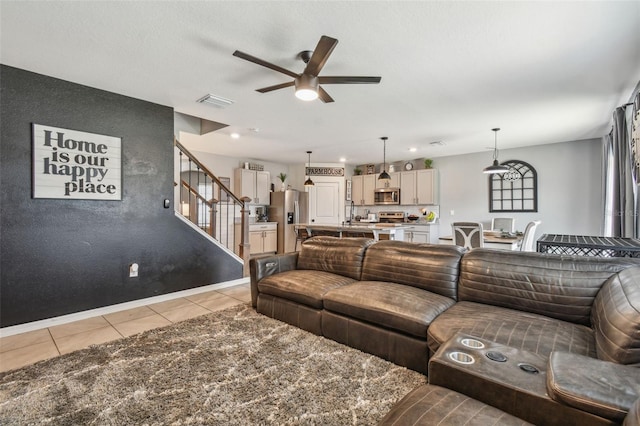 33678 Jasper Stone Dr, Wesley Chapel, FL 33543 - living area with ceiling fan, light tile patterned floors, and stairs