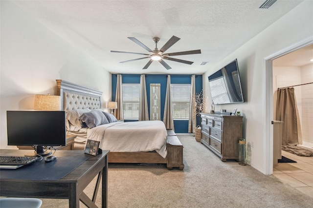 33678 Jasper Stone Dr, Wesley Chapel, FL 33543 - bedroom featuring light carpet, connected bathroom, a ceiling fan, and a textured ceiling