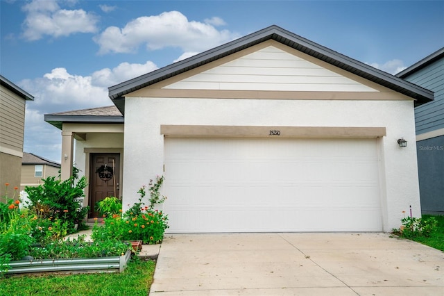 35210 Daisy Meadow Loop, Zephyrhills, FL 33541 - view of front of house featuring driveway, a garage, and stucco siding