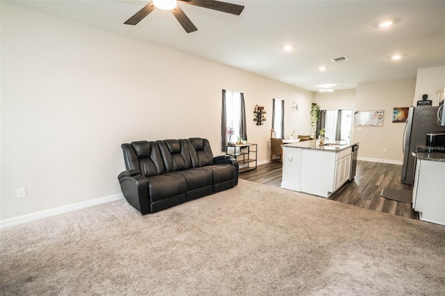 35210 Daisy Meadow Loop, Zephyrhills, FL 33541 - living room featuring ceiling fan, recessed lighting, dark wood-style flooring, and dark carpet
