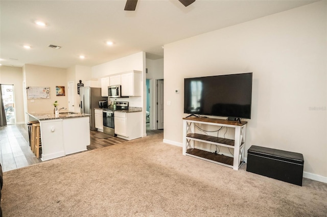 35210 Daisy Meadow Loop, Zephyrhills, FL 33541 - kitchen featuring appliances with stainless steel finishes, open floor plan, stone counters, white cabinetry, and ceiling fan