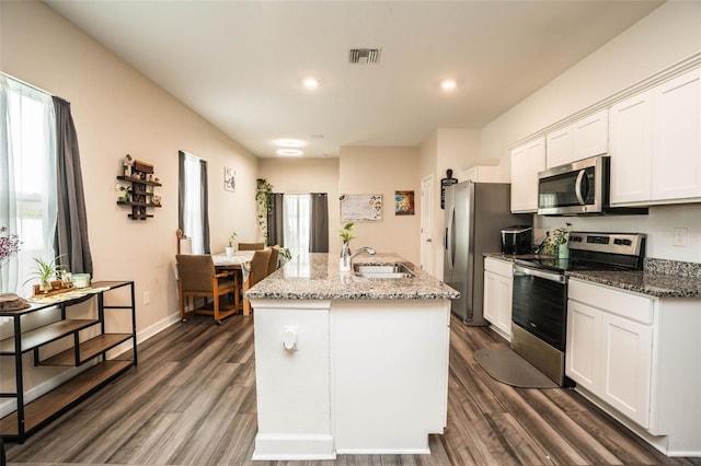 35210 Daisy Meadow Loop, Zephyrhills, FL 33541 - kitchen with appliances with stainless steel finishes, healthy amount of natural light, dark wood-style flooring, an island with sink, and recessed lighting