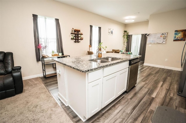 35210 Daisy Meadow Loop, Zephyrhills, FL 33541 - kitchen with stainless steel dishwasher, light stone countertops, a center island with sink, white cabinetry, and dark wood-style floors