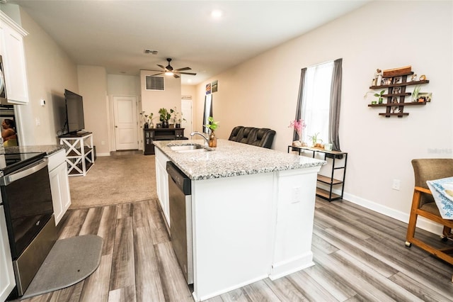 35210 Daisy Meadow Loop, Zephyrhills, FL 33541 - kitchen with appliances with stainless steel finishes, a ceiling fan, white cabinetry, and light wood-style floors