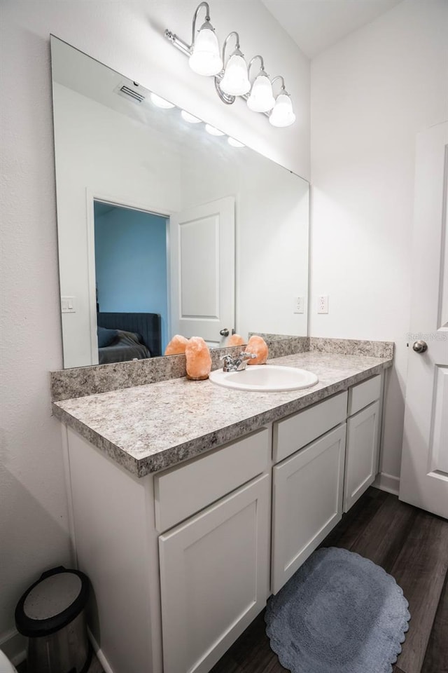 35210 Daisy Meadow Loop, Zephyrhills, FL 33541 - ensuite bathroom featuring vanity and wood finished floors