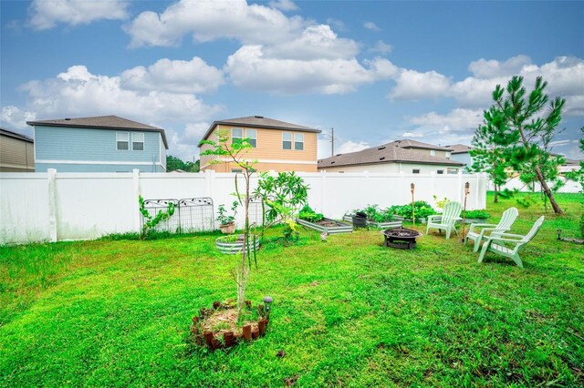 35210 Daisy Meadow Loop, Zephyrhills, FL 33541 - view of yard featuring an outdoor fire pit and a vegetable garden