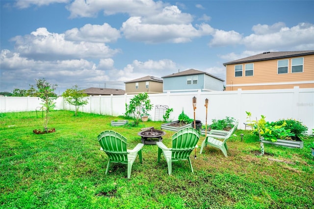35210 Daisy Meadow Loop, Zephyrhills, FL 33541 - fenced backyard with a fire pit and a garden