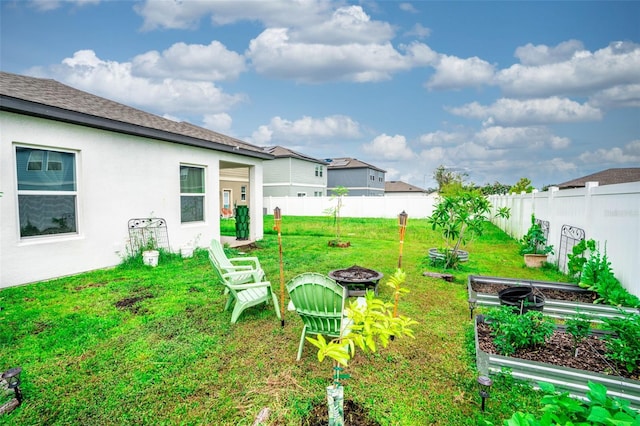 35210 Daisy Meadow Loop, Zephyrhills, FL 33541 - fenced backyard featuring an outdoor fire pit and a garden