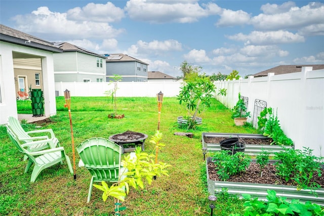 35210 Daisy Meadow Loop, Zephyrhills, FL 33541 - fenced backyard featuring an outdoor fire pit and a vegetable garden