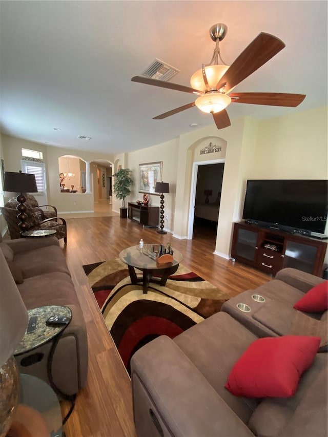 11439 Cambray Creek Loop, Riverview, FL 33579 - living room featuring arched walkways, wood finished floors, and a ceiling fan