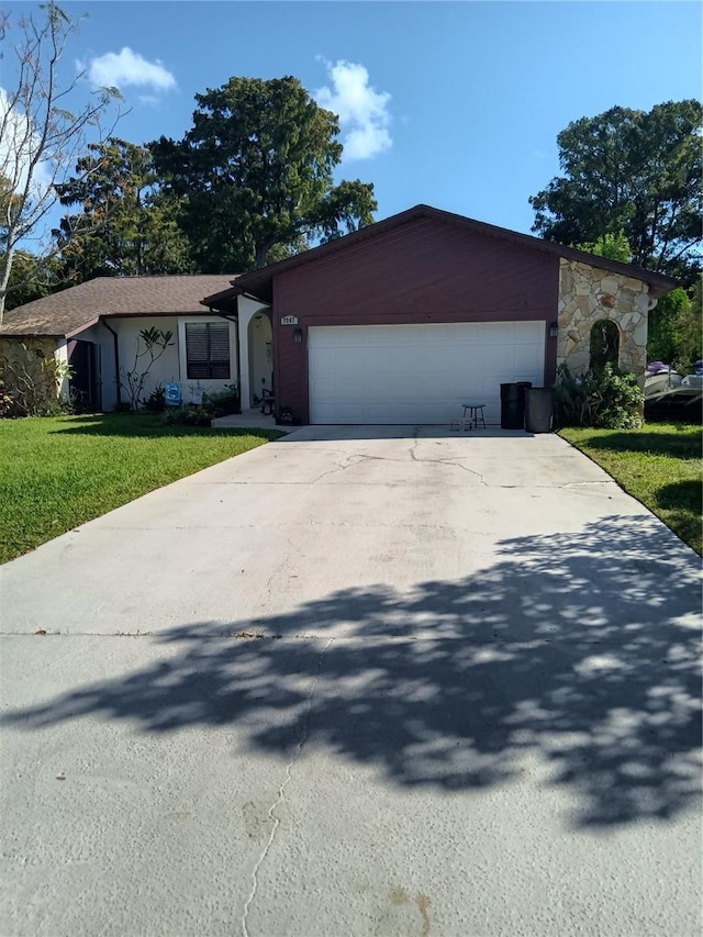 7307 Windsor Mill Rd, Hudson, FL 34667 - view of front of property featuring an attached garage, driveway, and a front yard