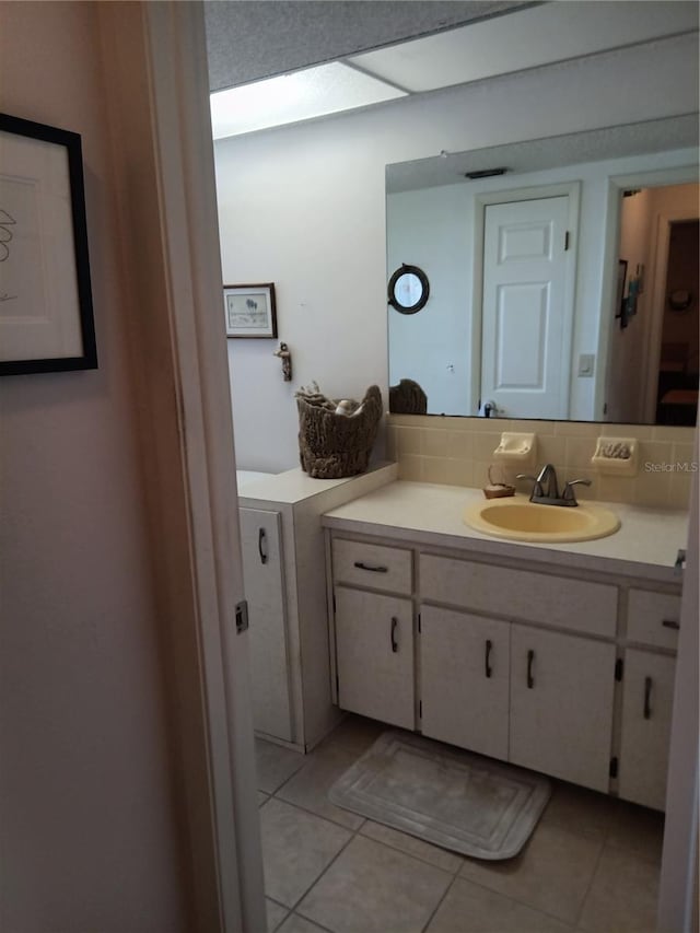 7307 Windsor Mill Rd, Hudson, FL 34667 - bathroom featuring tile patterned floors, vanity, and decorative backsplash