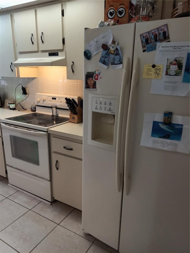 7307 Windsor Mill Rd, Hudson, FL 34667 - kitchen featuring white appliances, under cabinet range hood, light countertops, white cabinets, and backsplash