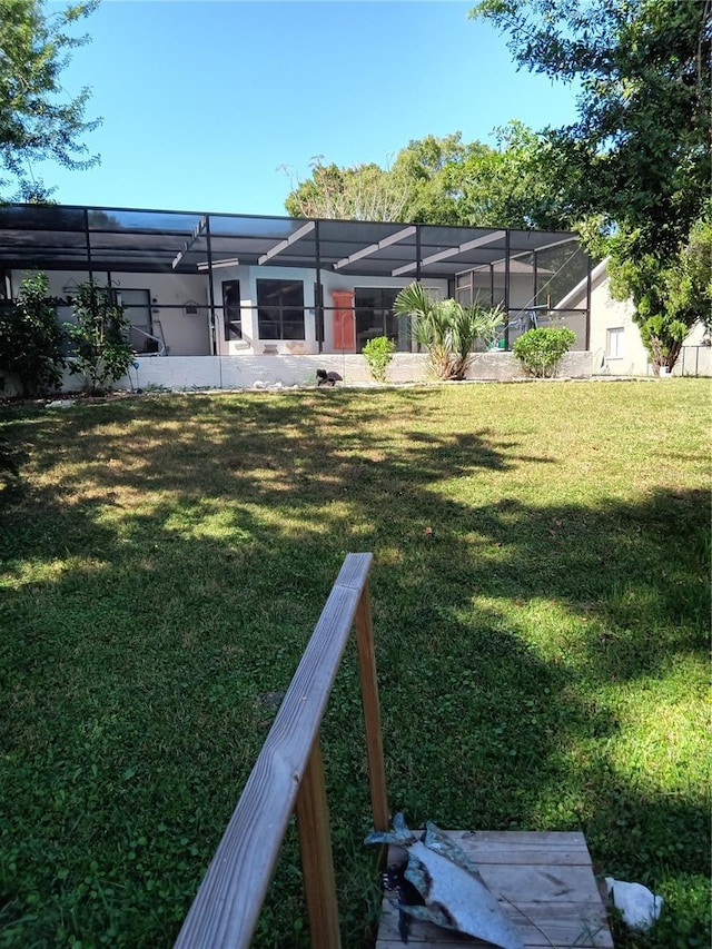 7307 Windsor Mill Rd, Hudson, FL 34667 - back of house with a lawn and a lanai