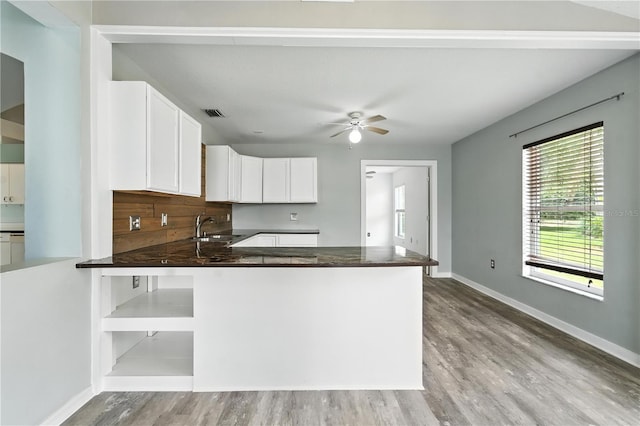 1725 Bondurant Way, Brandon, FL 33511 - kitchen featuring dark countertops, light wood finished floors, white cabinets, a peninsula, and a ceiling fan