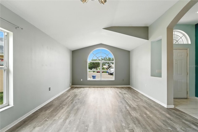 1725 Bondurant Way, Brandon, FL 33511 - unfurnished living room featuring wood finished floors, vaulted ceiling, and a chandelier