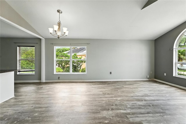 1725 Bondurant Way, Brandon, FL 33511 - spare room with a chandelier, vaulted ceiling, and wood finished floors