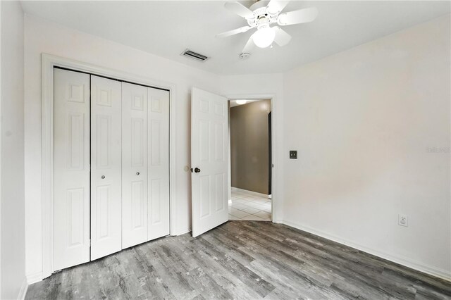 1725 Bondurant Way, Brandon, FL 33511 - unfurnished bedroom with wood finished floors, a closet, and a ceiling fan