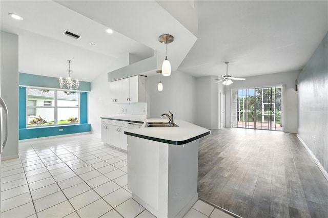 1725 Bondurant Way, Brandon, FL 33511 - kitchen featuring a chandelier, white cabinets, a ceiling fan, hanging light fixtures, and vaulted ceiling