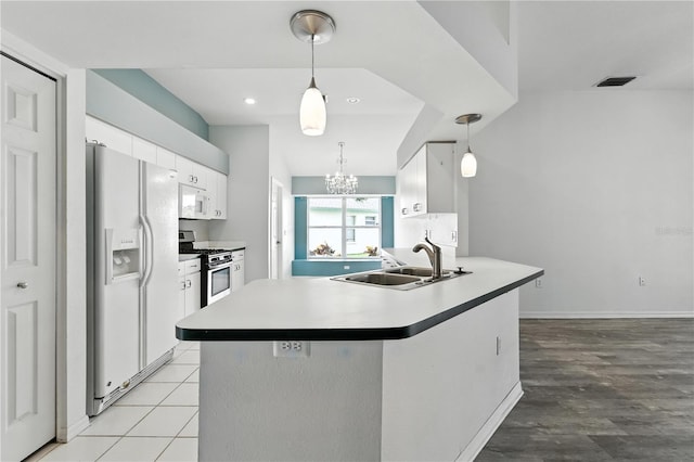 1725 Bondurant Way, Brandon, FL 33511 - kitchen with white appliances, white cabinetry, a chandelier, hanging light fixtures, and light countertops