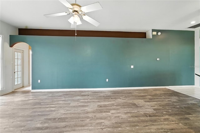 1725 Bondurant Way, Brandon, FL 33511 - unfurnished room with arched walkways, a ceiling fan, and wood finished floors