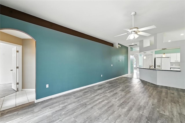 1725 Bondurant Way, Brandon, FL 33511 - unfurnished living room with a ceiling fan, arched walkways, and wood finished floors