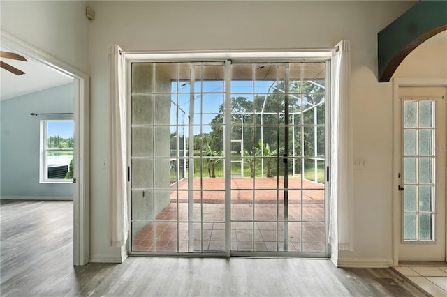 1725 Bondurant Way, Brandon, FL 33511 - doorway to outside featuring arched walkways, ceiling fan, wood finished floors, and vaulted ceiling