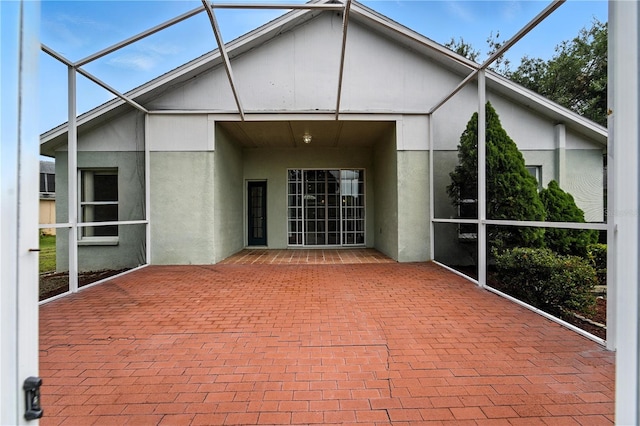 1725 Bondurant Way, Brandon, FL 33511 - rear view of property featuring a patio, stucco siding, and glass enclosure