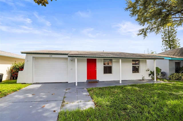 1018 Osprey Ct, Dunedin, FL 34698 - single story home with a garage, driveway, a front lawn, and stucco siding