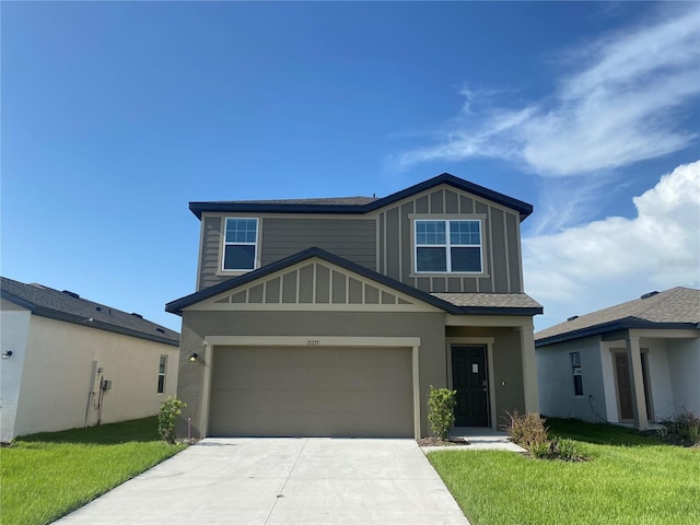 35233 White Water Lily Way, Zephyrhills, FL 33541 - view of front of home featuring concrete driveway, a front lawn, and board and batten siding
